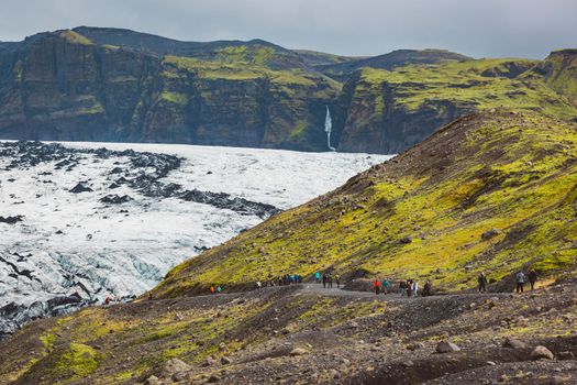 Hikers group on the Solheimajokull Glacier, Iceland, Panoramic view. High quality photo
