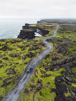 By the sea in West Iceland highlands, Snaefellsnes peninsula, View Point near Svortuloft Lighthouse. Spectacular black volcanic rocky ocean coast with cave arch and towers. High quality photo