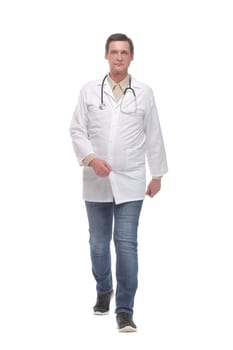 Full length portrait of young caucasian with stethoscope walking doctor isolated on white