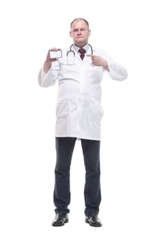 in full growth. competent doctor showing his visiting card. isolated on a white background.