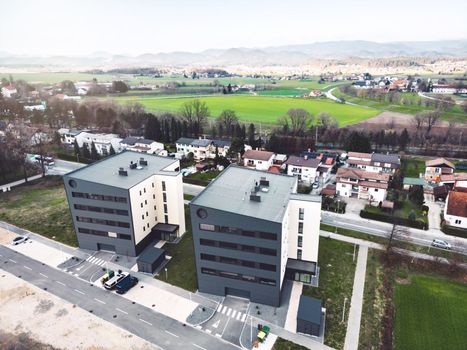 Aerial view, drone shoot, residential buildings on the outskirts of the city of Celje in Slovenia, some older and newer looking residential buildings.