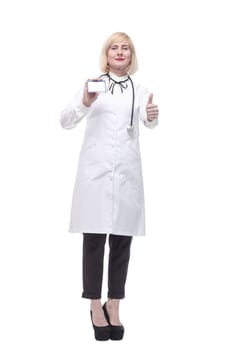 in full growth.qualified female doctor showing her visiting card. isolated on a white background.