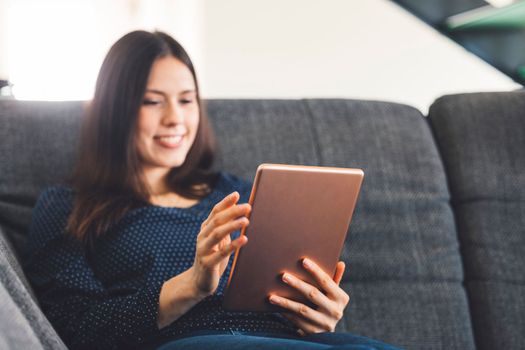 Young caucasian woman holding credit card and using laptop computer. Businesswoman working at home. Online shopping, e-commerce, internet banking, spending money, working from home concept. High quality photo