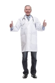 Cheerful mature doctor looking at camera and pointing away while standing against white background