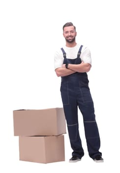 in full growth. smiling man standing near cardboard boxes. photo with copy space