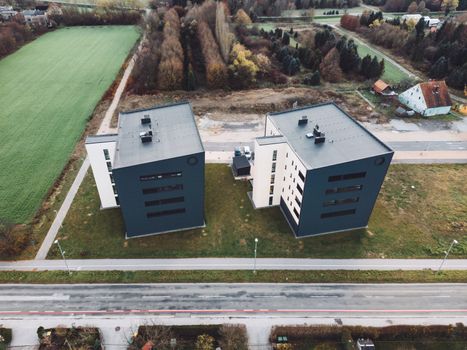 Aerial view, drone shoot, residential buildings on the outskirts of the city of Celje in Slovenia, some older and newer looking residential buildings.