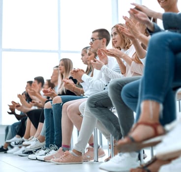 background image of young people applauding in the conference room. photo with copy space