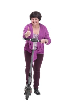 in full growth.happy senior woman with electric scooter. isolated on a white background.