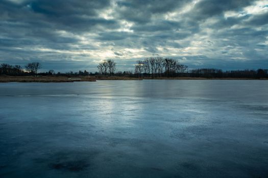 Evening view of a frozen lake and cloudy sky, Stankow eastern Poland