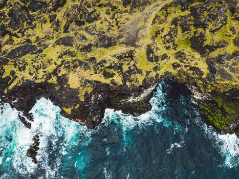 View of orange Svortuloft Lighthouse by the sea in West Iceland highlands, Snaefellsnes peninsula, View Point near Svortuloft Lighthouse. Spectacular black volcanic rocky ocean coast with cave arch and towers. High quality photo