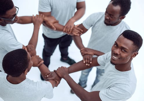 close up. group of diverse guys standing in a circle . isolated on white background