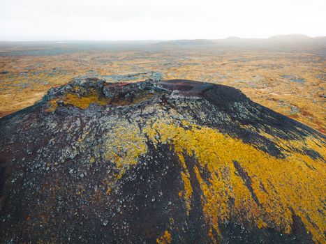 Geldingadalir active Volcano, errupting in 2021 - Fagradalsfjall and 2022 -Meradalir. Still hot lava rocks, steam comping up from the grounds. Dark grey, black volcanic rocks in Iceland. Dramatic view of lava rocks cold cloudy autumn day in Iceland.