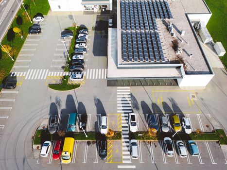 Aerial view of industrial building with a large parking lot somewhere in the countryside of Slovenia.