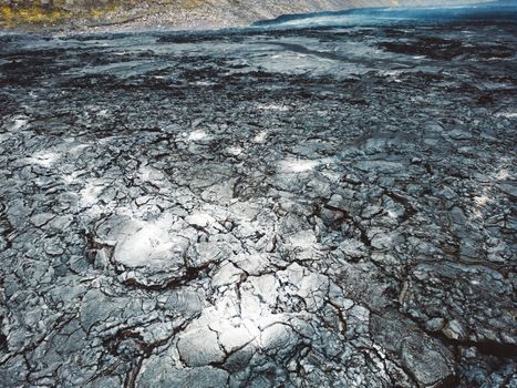 Geldingadalir active Volcano, errupting in 2021 - Fagradalsfjall and 2022 -Meradalir. Still hot lava rocks, steam comping up from the grounds. Dark grey, black volcanic rocks in Iceland. Dramatic view of lava rocks cold cloudy autumn day in Iceland.