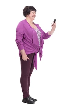 in full growth.casual an elderly woman with a smartphone. isolated on a white background.