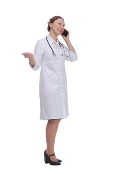 in full growth.female doctor with a smartphone. isolated on a white background.