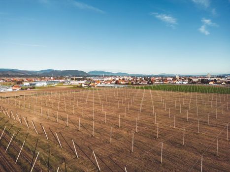 Aerial view of agricultural fields in the country side of Slovenia on a sunny day.