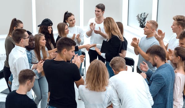 young people shaking hands in a circle of like-minded people. photo with copy space