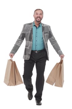in full growth. happy man with shopping bags. isolated on a white background.