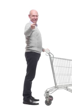 in full growth. a happy man with a shopping cart. isolated on a white background.