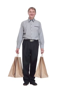 in full growth.senior man with shopping bags . isolated on a white background.