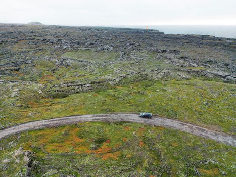 By the sea in West Iceland highlands, Snaefellsnes peninsula, View Point near Svortuloft Lighthouse. Spectacular black volcanic rocky ocean coast with cave arch and towers. High quality photo