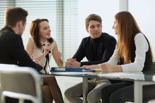 happy business team is standing in the office applauding. the concept of success.