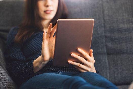 Young caucasian woman holding credit card and using laptop computer. Businesswoman working at home. Online shopping, e-commerce, internet banking, spending money, working from home concept. High quality photo