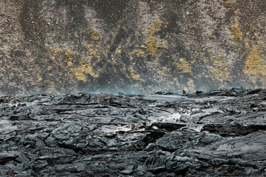 Geldingadalir active Volcano, errupting in 2021 - Fagradalsfjall and 2022 -Meradalir. Still hot lava rocks, steam comping up from the grounds. Dark grey, black volcanic rocks in Iceland. Dramatic view of lava rocks cold cloudy autumn day in Iceland.