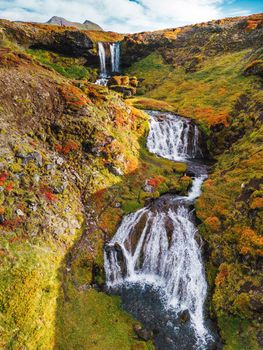 Sheep's Waterfall. Famous tourist landscape. Travel concept background. Dramatic autumn sun, Iceland, Atlantic Ocean, Europe. Travel postcard. High quality photo