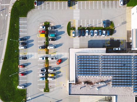 Aerial view of industrial building with a large parking lot somewhere in the countryside of Slovenia.