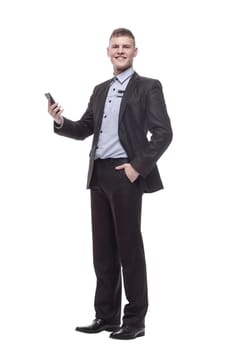 in full growth. happy young businessman with a new smartphone . isolated on a white background.