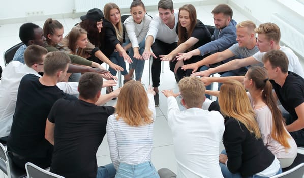 group of diverse young people joining their palms together. the concept of team building