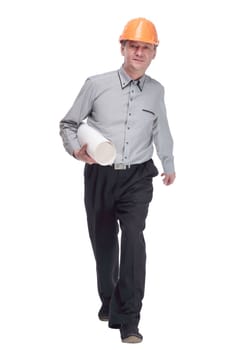 in full growth. man in a protective helmet with a roll of blueprints striding forward . isolated on a white background.
