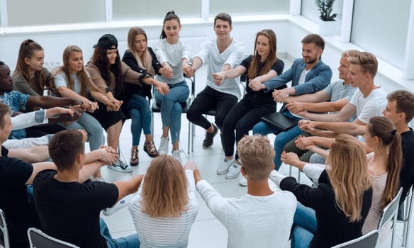 group of young like-minded people holding each other's hands. business and education