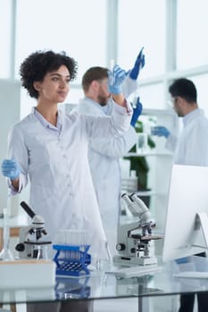 Team of Scientists Working Using Microscope, Analysing Microbiology Samples