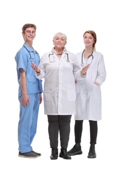 Portrait of a female doctor with two of her co-workers against white background showing welcome gesture