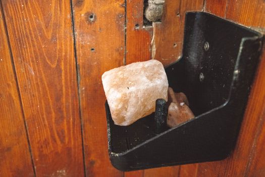 Rock salt for the horse to lick inside the horse stable on a shelf. 