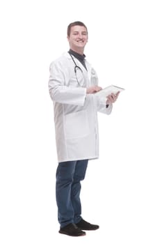 in full growth. modern doctor with a digital tablet. isolated on a white background.