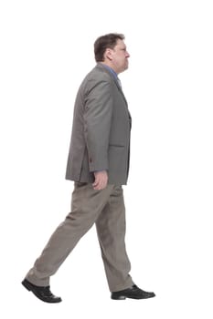 full-length. casual man in a grey jacket striding forward. isolated on a white background.