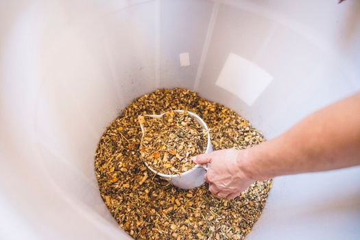 Buckets filled with grain to feed the horses together with hay. Food for animals on the ranch.