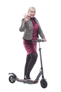 in full growth. attractive happy woman with an electric scooter. isolated on a white background.
