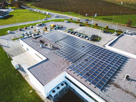 Aerial view of industrial building with a large parking lot somewhere in the countryside of Slovenia. 