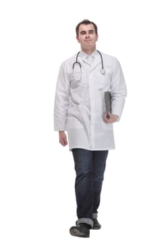 Side view of cheerful mature doctor looking at camera and smiling with clipboard, standing against white background