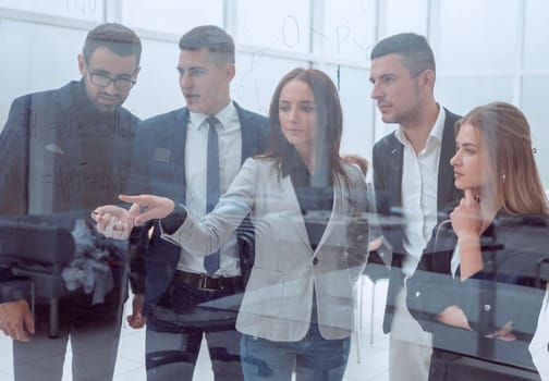 close up. business team standing in front of a glass wall.
