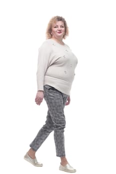 casual woman in a jumper and trousers striding forward. isolated on a white background.