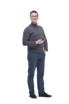 in full growth. casual young man with a smartphone. isolated on a white background.