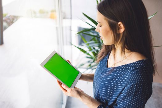 Young caucasian woman holding credit card and using laptop computer. Businesswoman working at home. Online shopping, e-commerce, internet banking, spending money, working from home concept. High quality photo