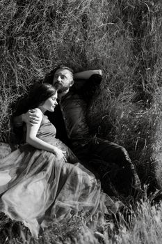 pregnant girl and boyfriend on high hills near the sea