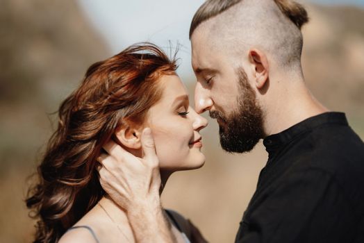 pregnant girl and boyfriend on high hills near the sea